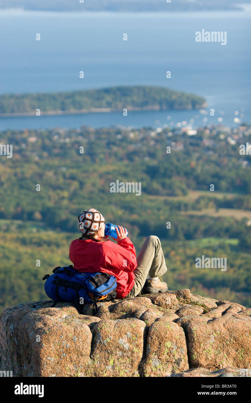 Young woman hiking on Cadillac Mountain in Acadia National Park. Bar