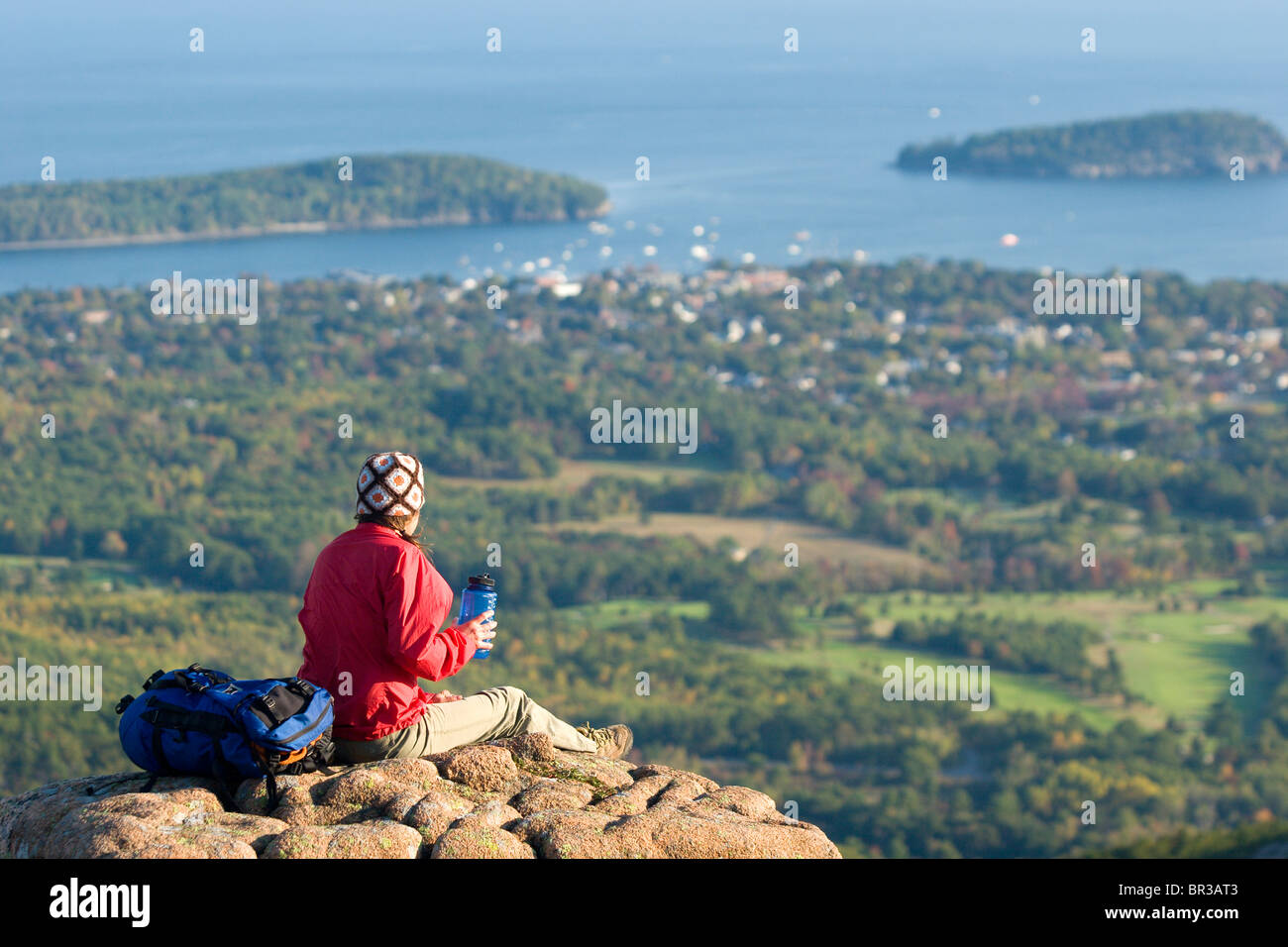 Young woman hiking on Cadillac Mountain in Acadia National Park. Bar
