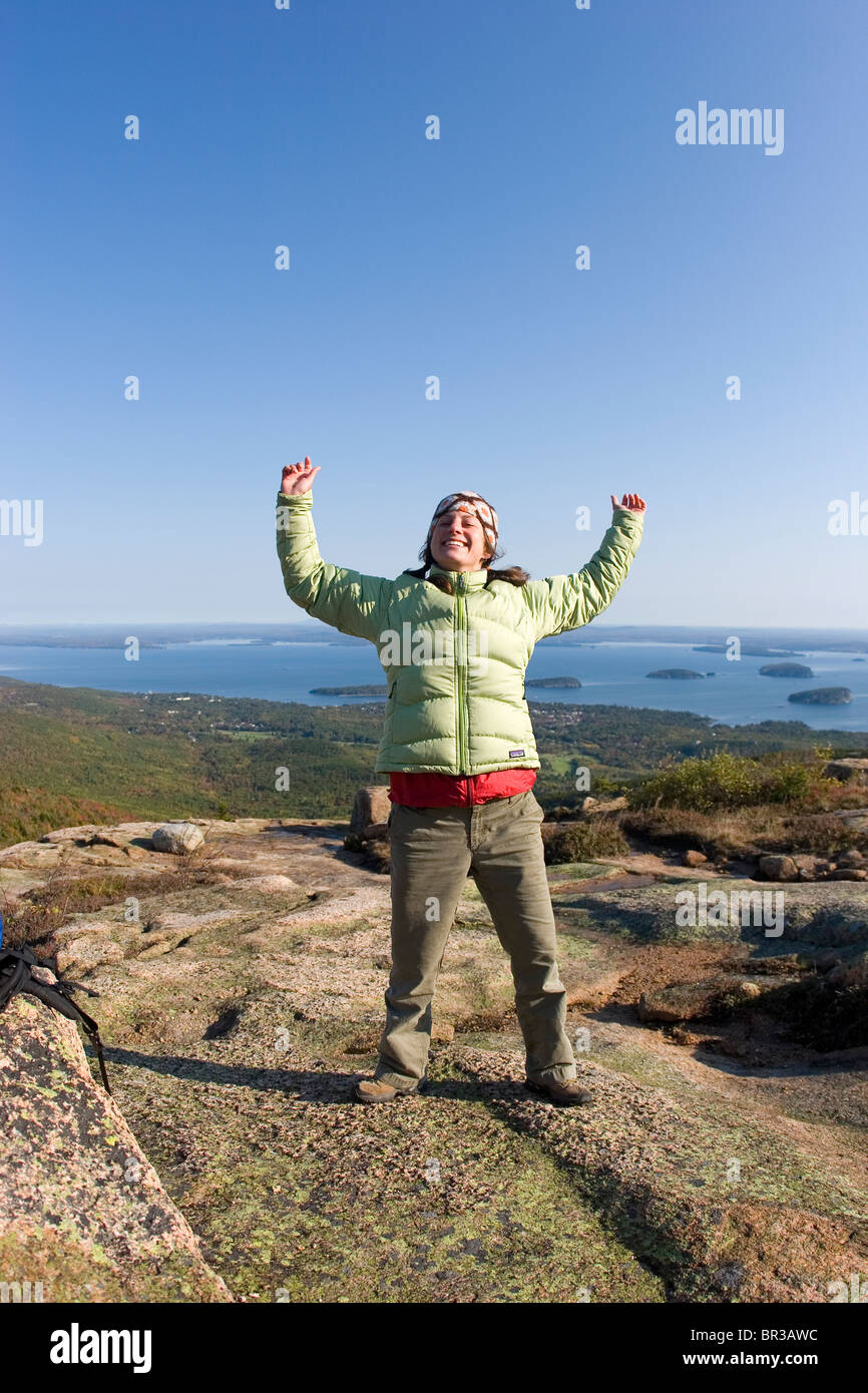 Young woman hiking on Cadillac Mountain in Acadia National Park. Bar