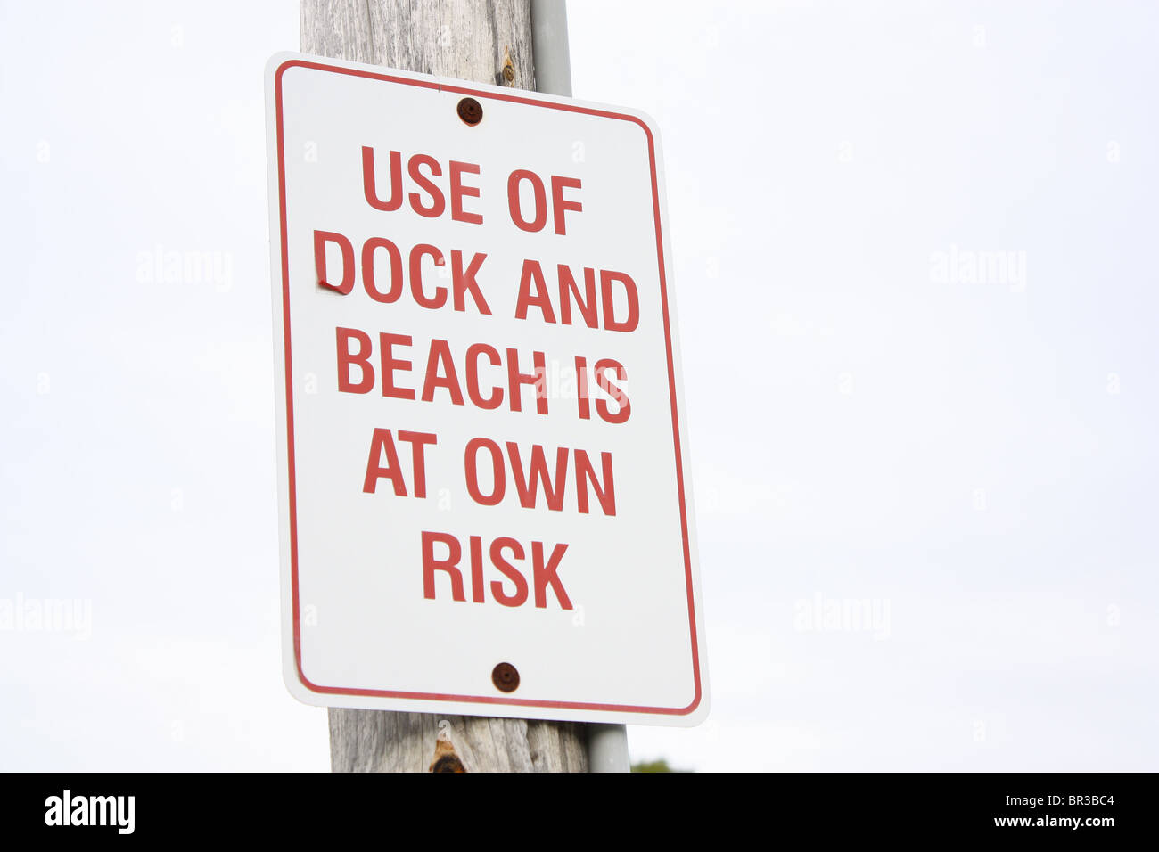 use of dock and beach is at own risk sign Stock Photo