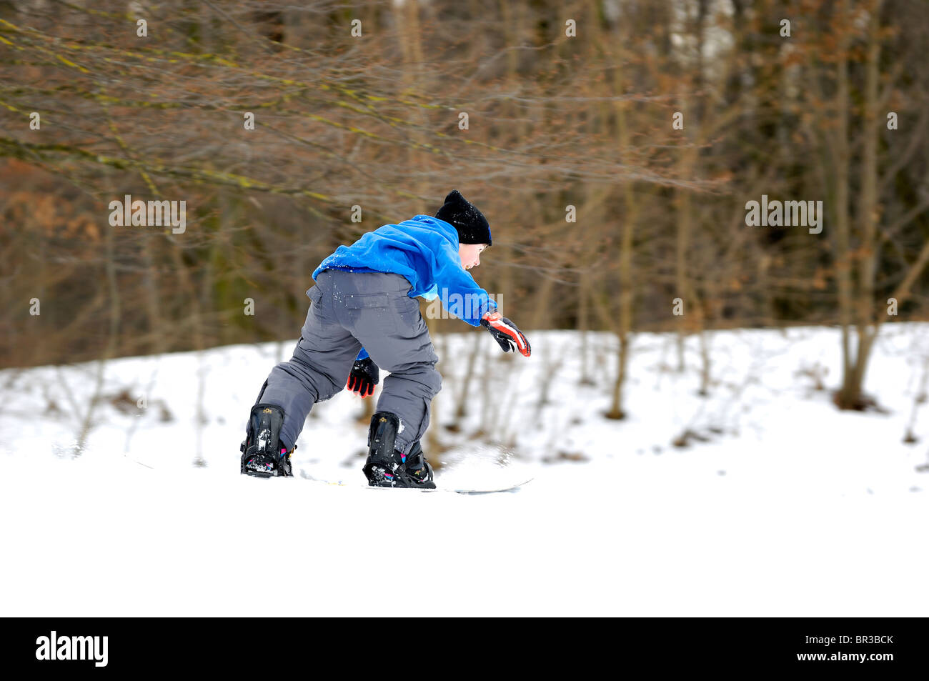 Young Snowboarder at full speed Stock Photo