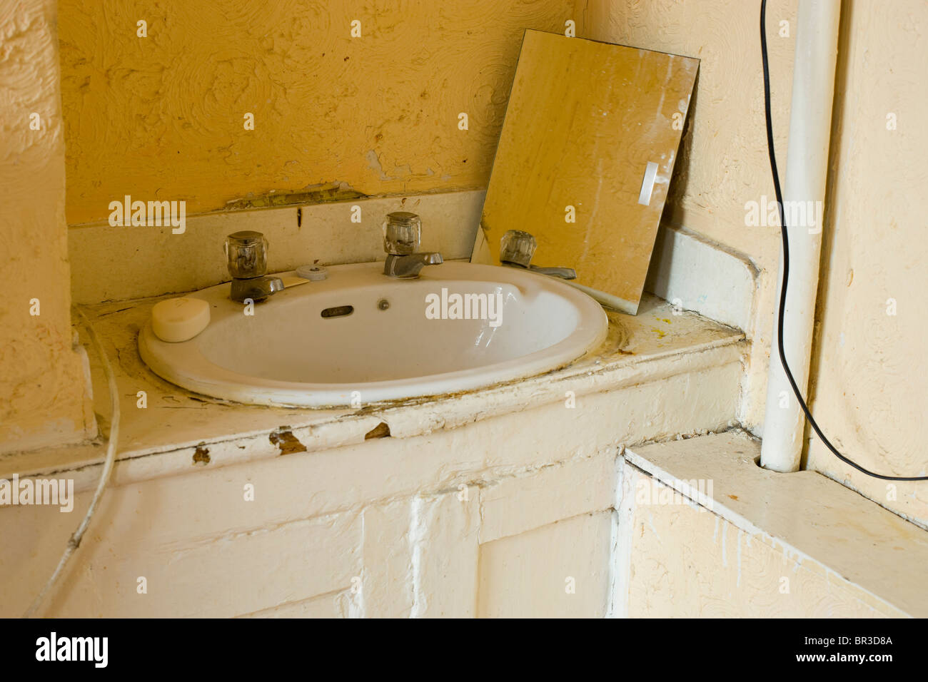 sink in a run down bedsit hostel room Stock Photo