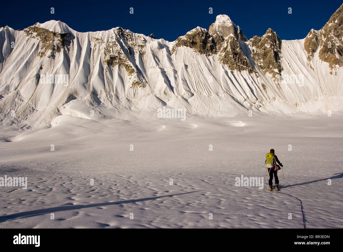 A woman ski mountaineering on the Biafo glacier in the Karakoram himalaya of Pakistan Stock Photo