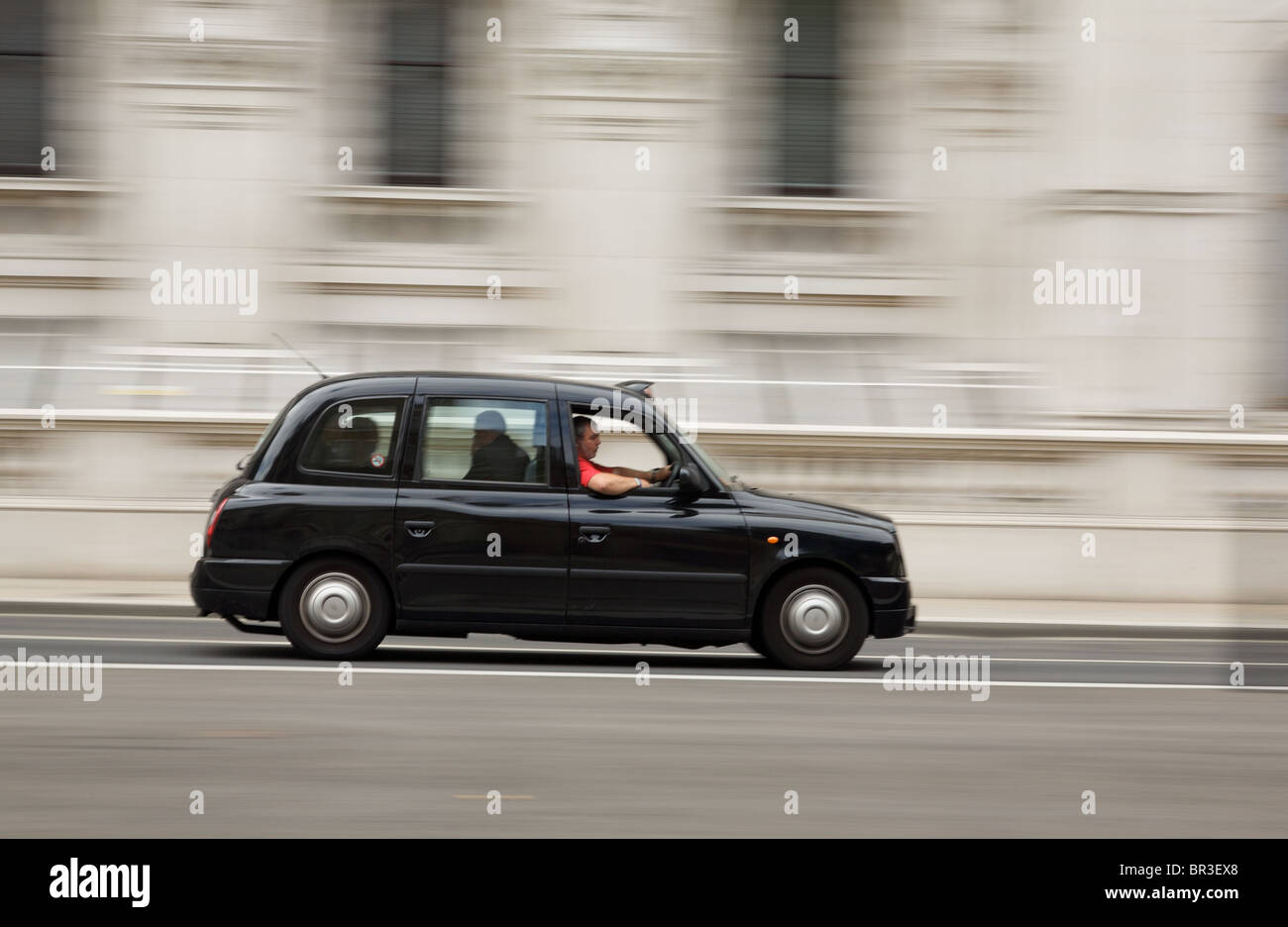 London taxi moving along Whitehall Stock Photo