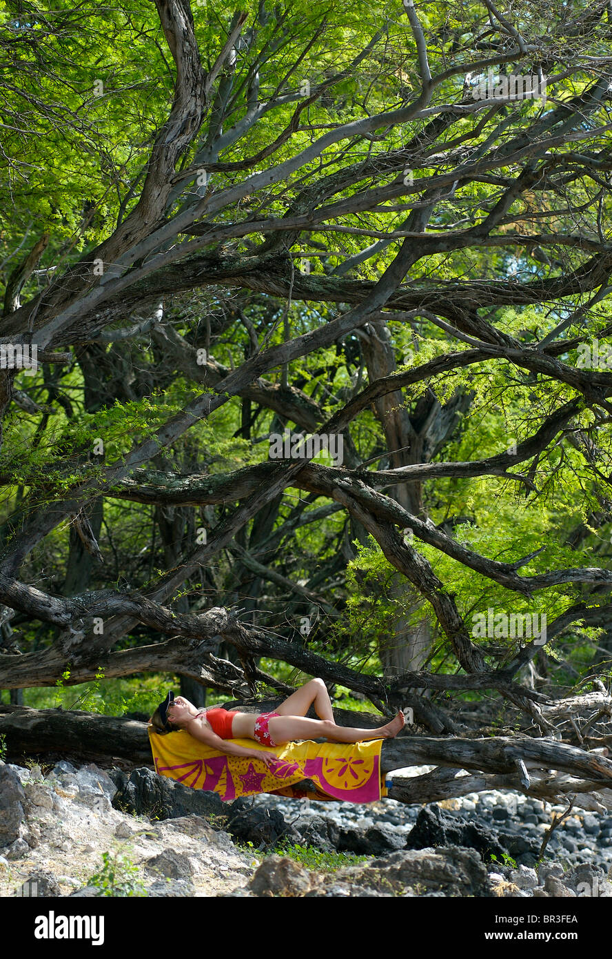 a woman relaxing at Ahihi Bay on the island of Maui, Hawaii. Stock Photo
