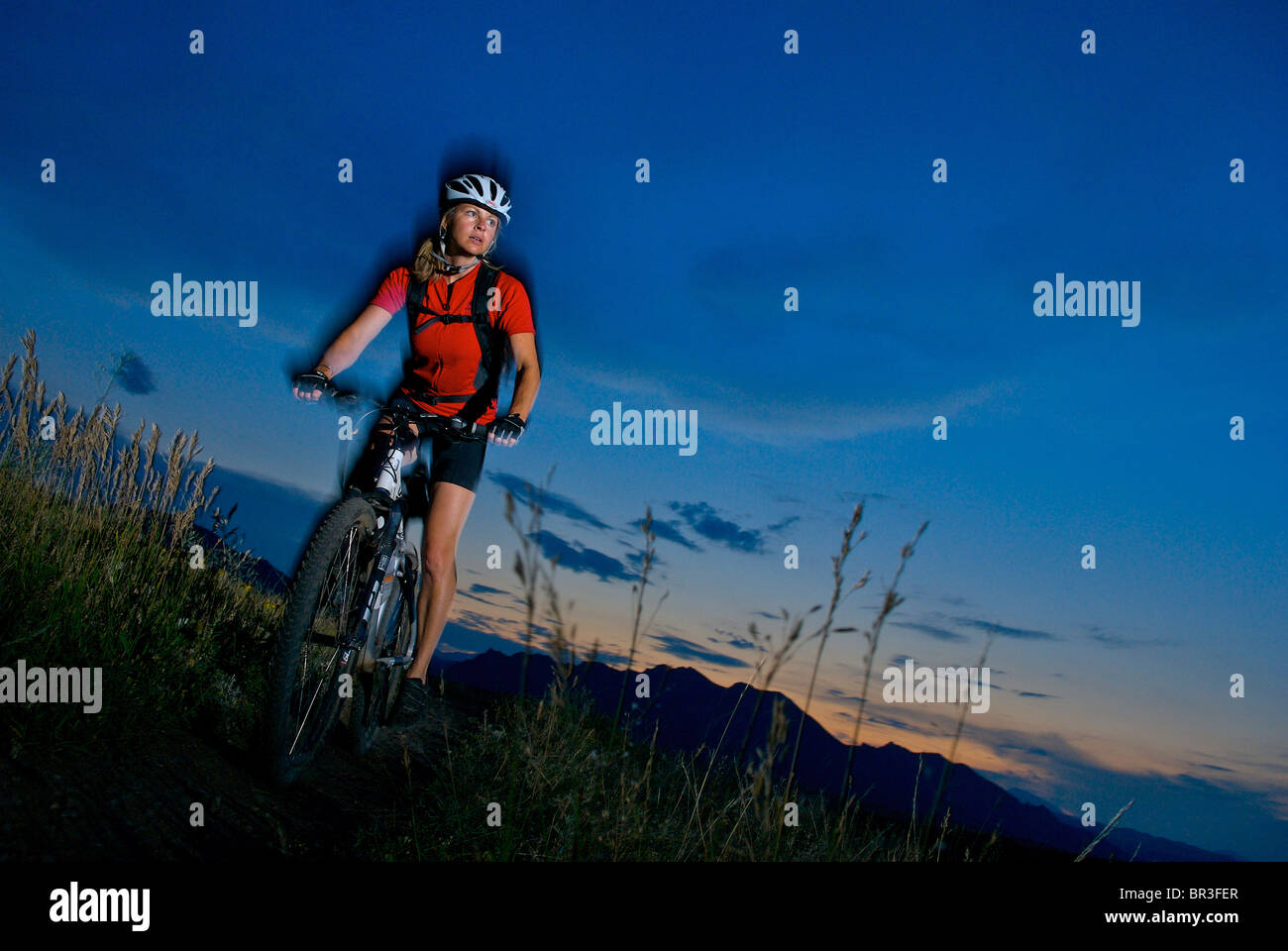 A woman moutain biking at Marshal Mesa, Co. (motion blur with flash). Stock Photo
