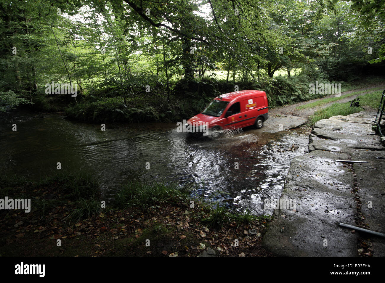 Rural Post Office Deliveries, PO Van crossing a ford in Cornwall Stock Photo