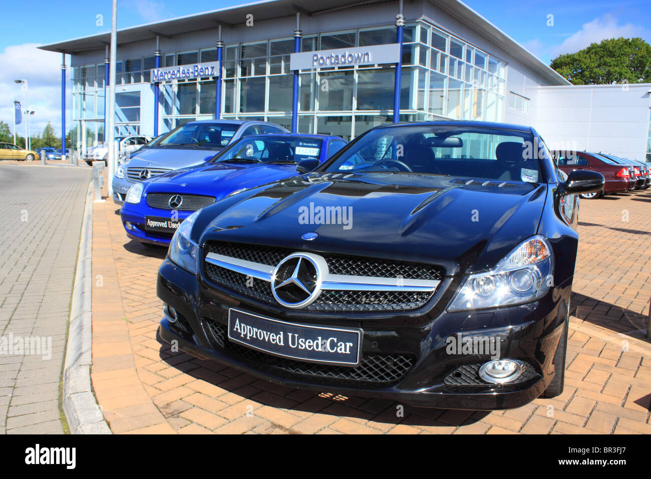 Row of used cars for sale on a Mercedes-Benz dealership forecourt Stock Photo