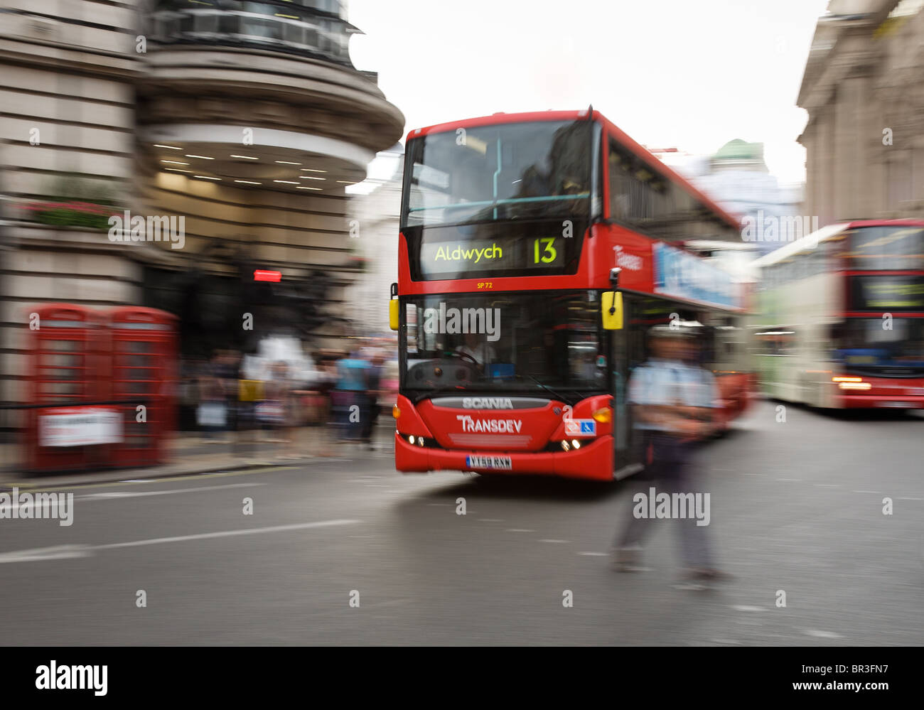 London bus at speed in central London Stock Photo