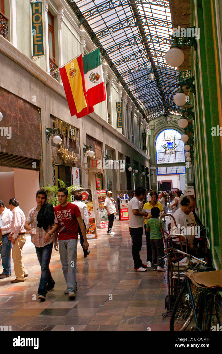 People in a covered pedestrian walkway and shopping mall, Puebla, Mexico. Puebla is a UNESCO World Heritage Site. Stock Photo