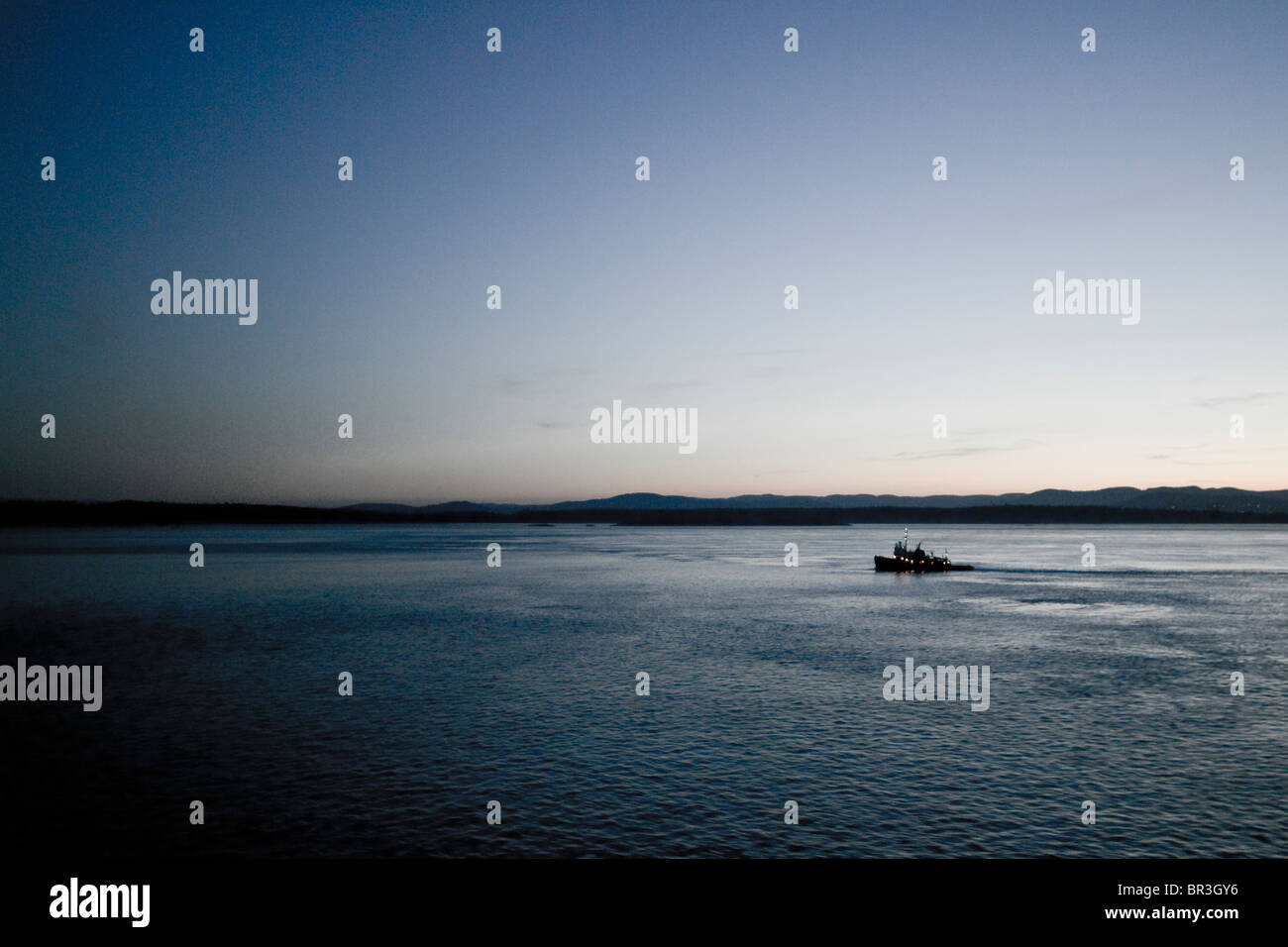 Fishing boat on the Pacific ocean at sunset. Stock Photo