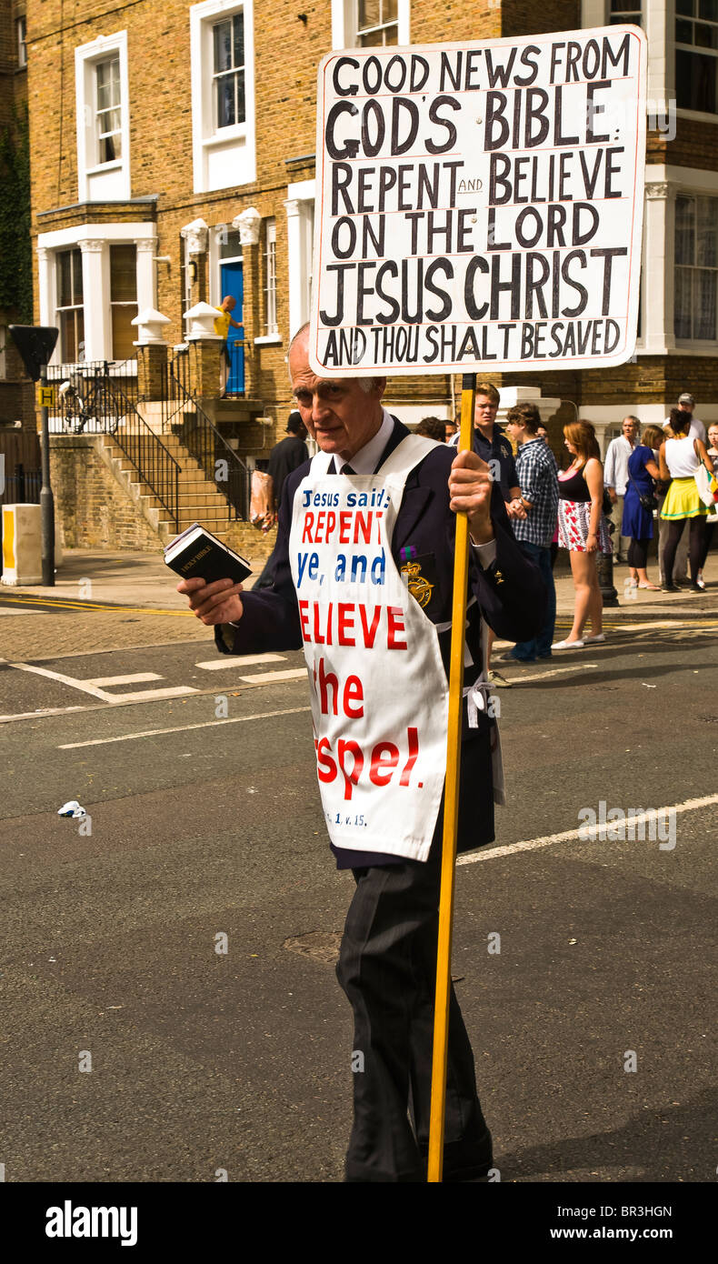 A street evangelist communicating his message with bible and placard at the 2009 Notting Hill Carnival Stock Photo