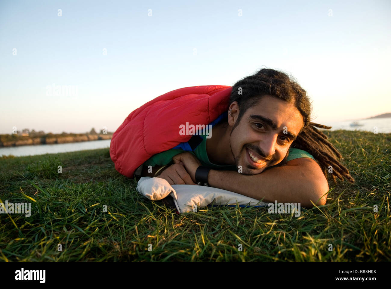 Man inside sleeping bag on the coast of Maine, New England. Stock Photo