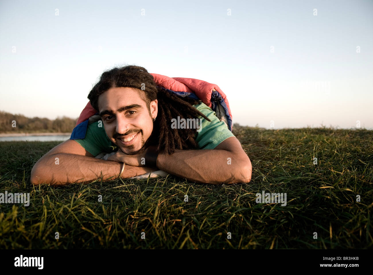 Man inside sleeping bag on the coast of Maine, New England. Stock Photo