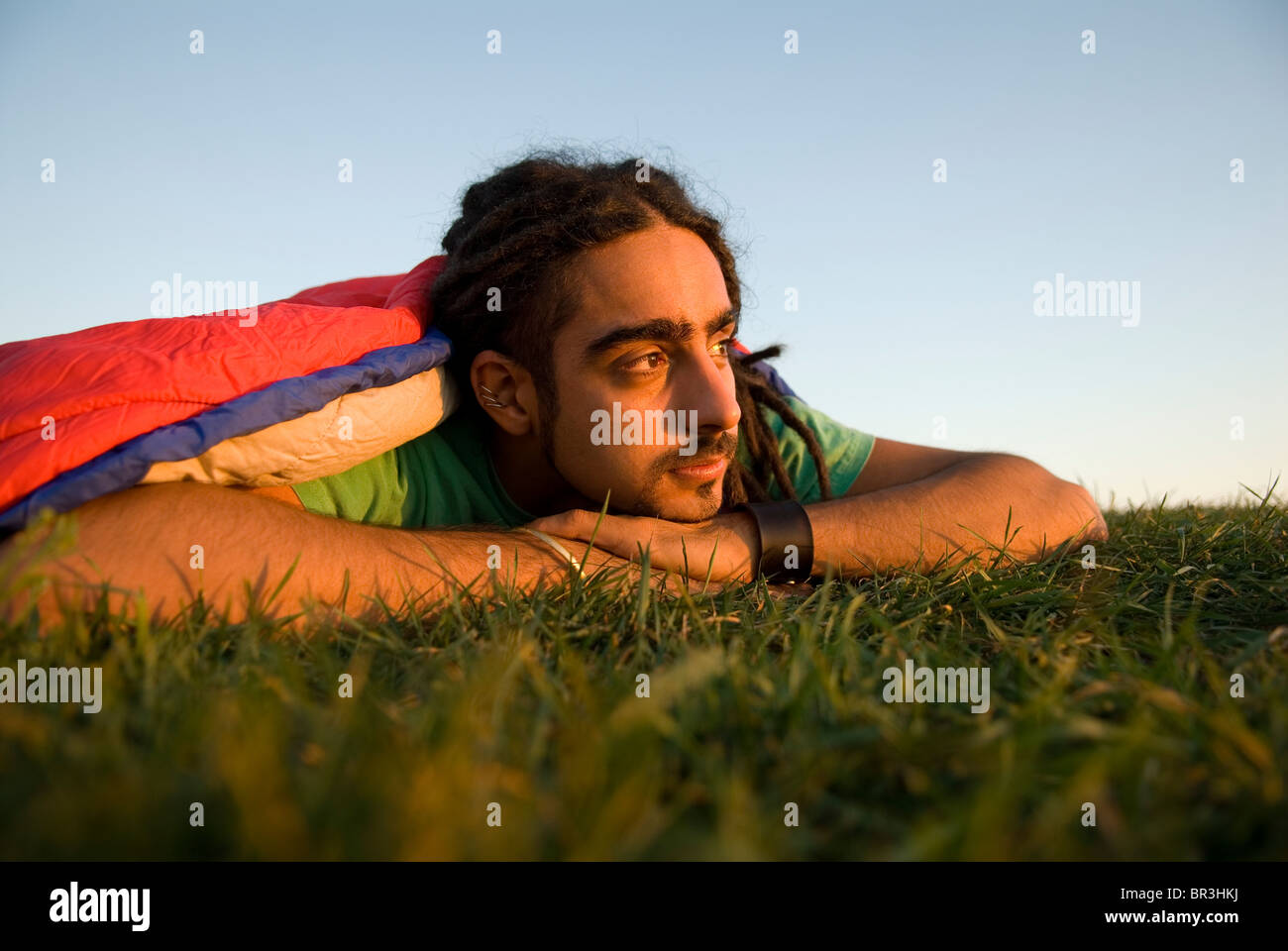 Man inside sleeping bag on the coast of Maine, New England. Stock Photo