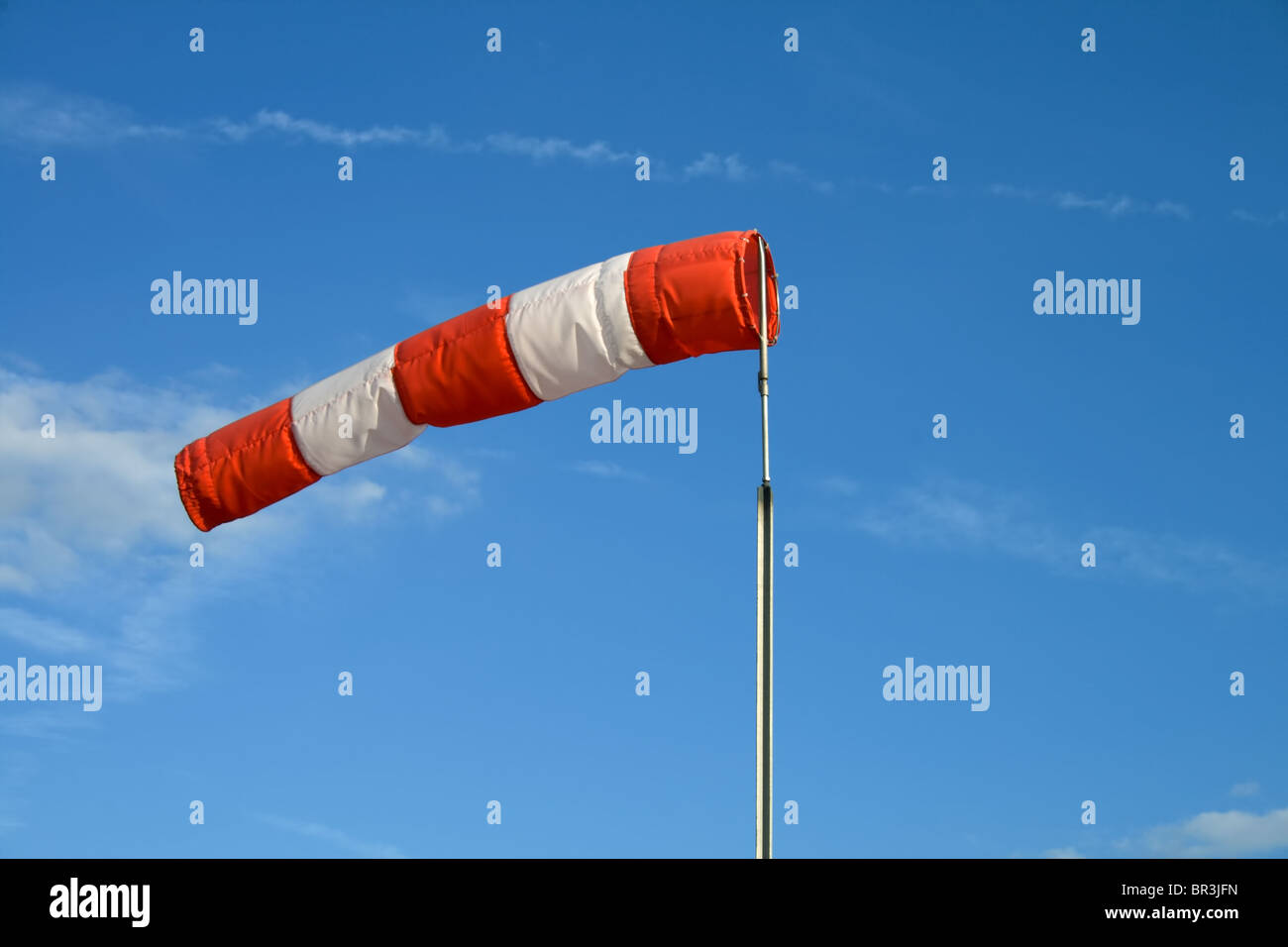 Wind sock in front of blue sky Stock Photo