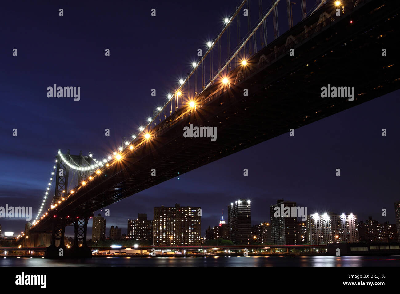 New York City Skyline and Manhattan Bridge At Night Stock Photo - Alamy