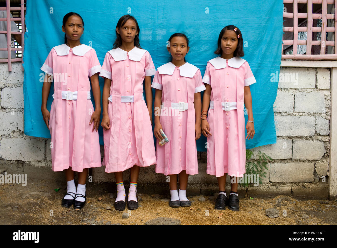 Young Filipinas in line for school ID photos at Penaverde Montessori School in Mansalay, Oriental Mindoro, Philippines. Stock Photo