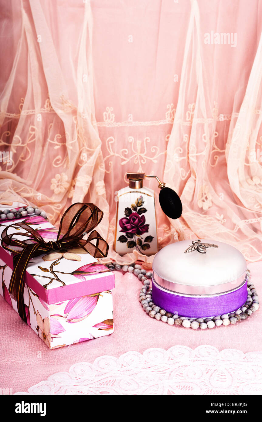 Feminine birthday or holiday celebration with gift box, perfume and talcum powder Stock Photo