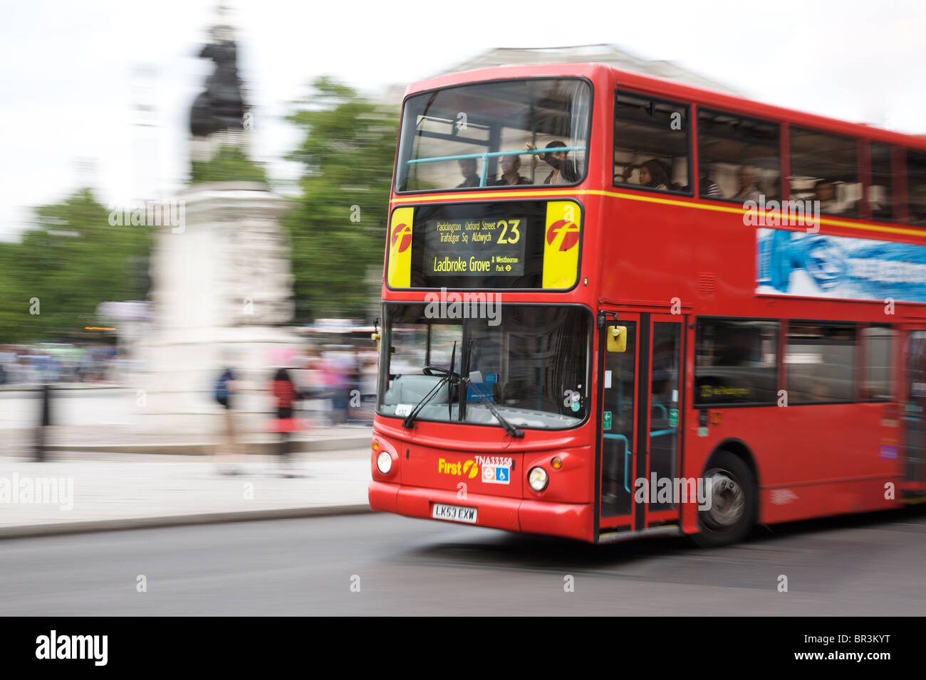 London bus travelling around Trafalgar Square Stock Photo