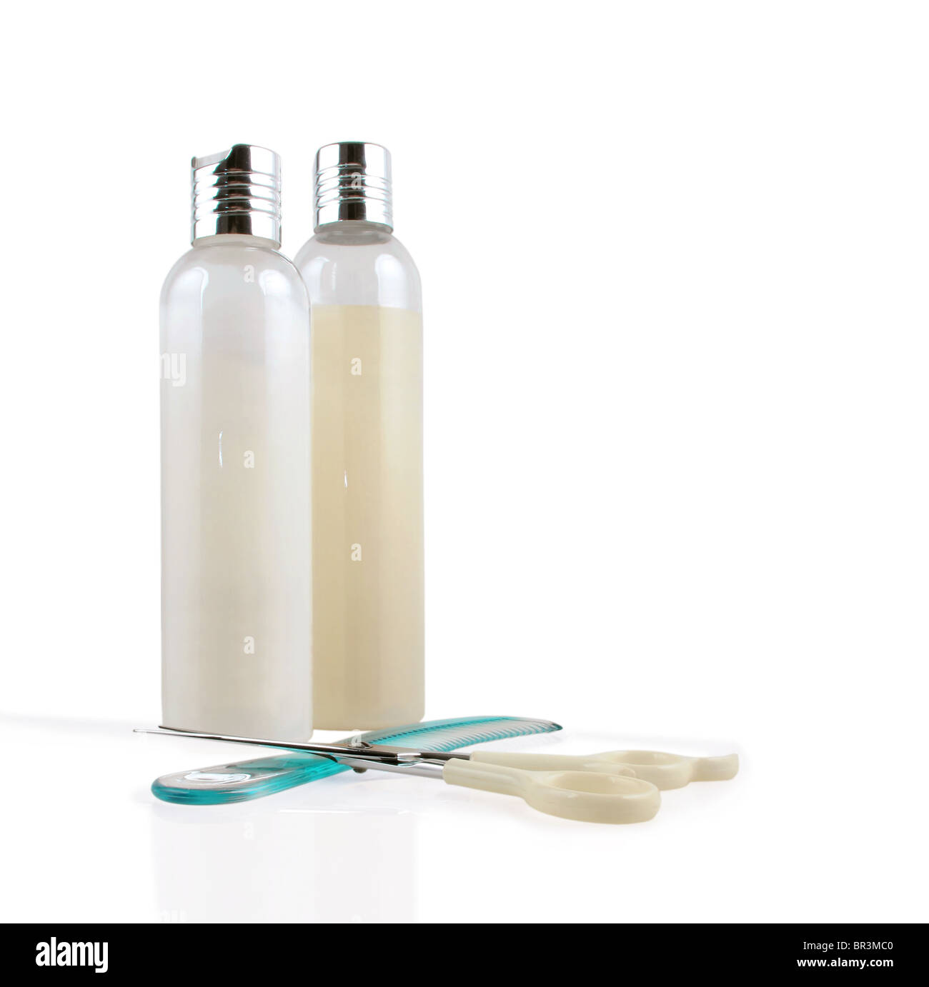 Shampoo, conditioner, comb and scissor on a white background Stock Photo