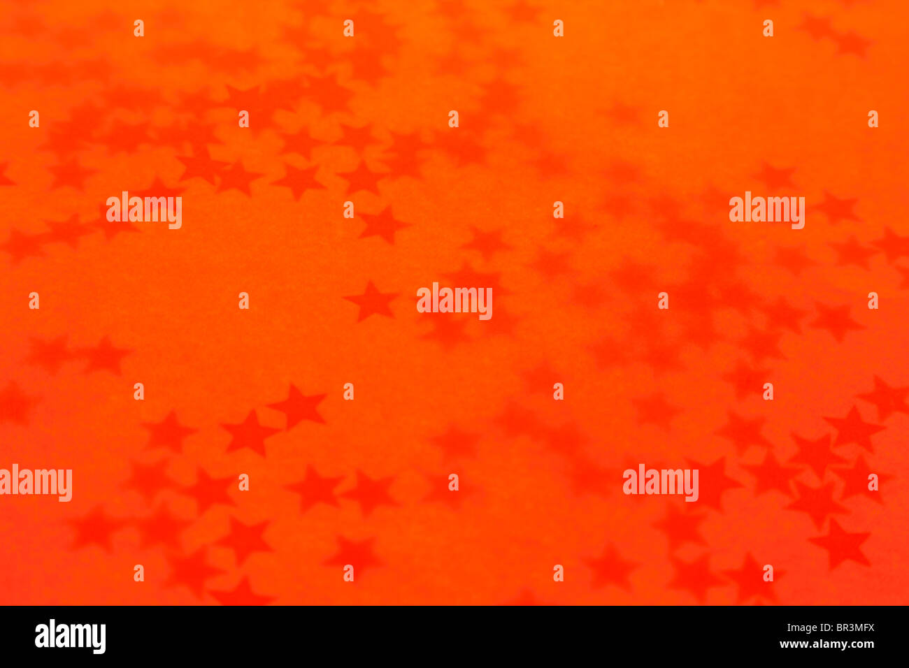 Old orange holiday wallpaper with a stars Stock Photo