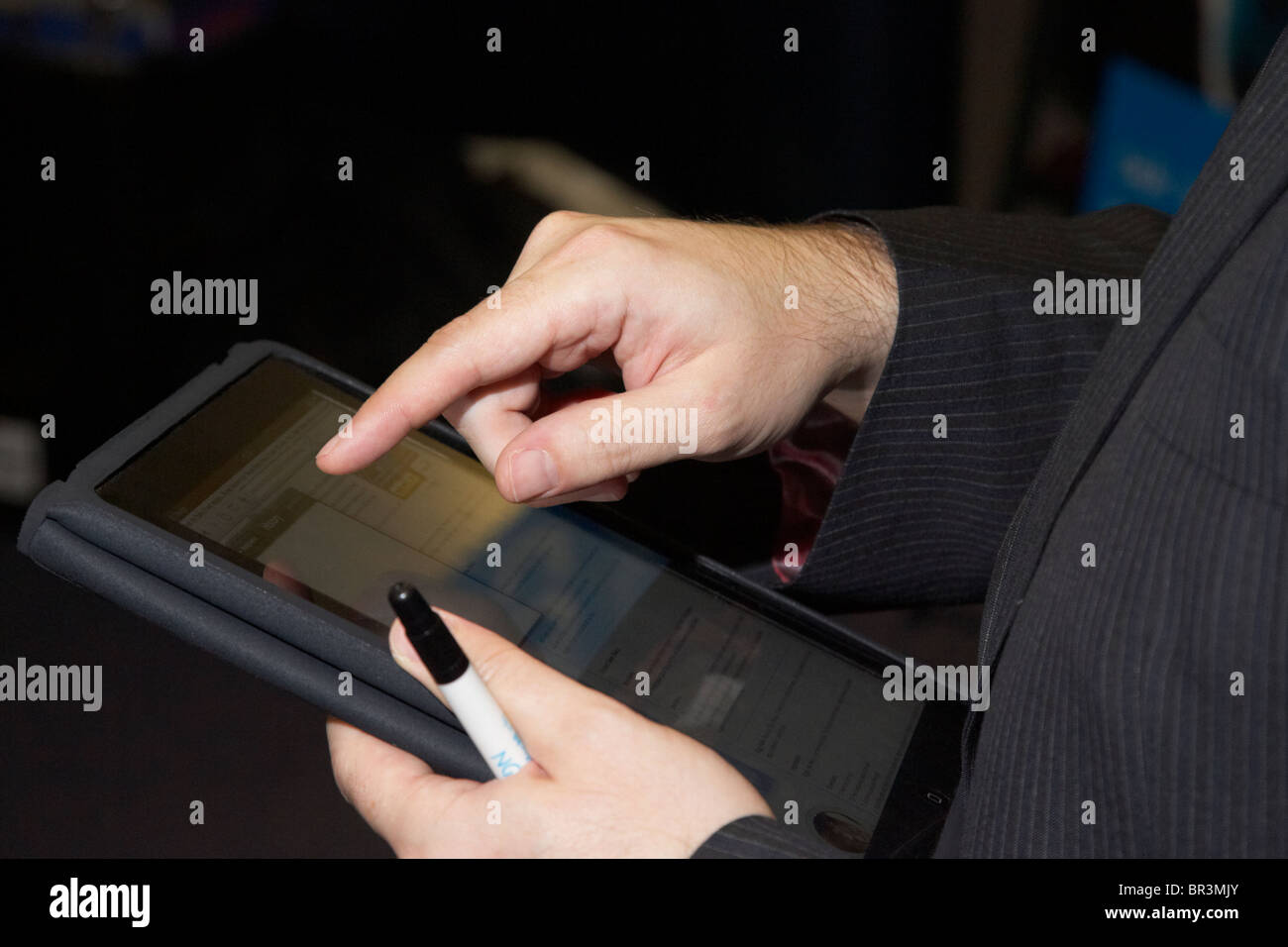 businessman using an apple ipad touchscreen tablet computer Stock Photo
