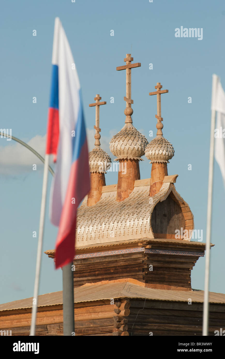 Russian flag on the Russian orthodox wooden church background Stock Photo