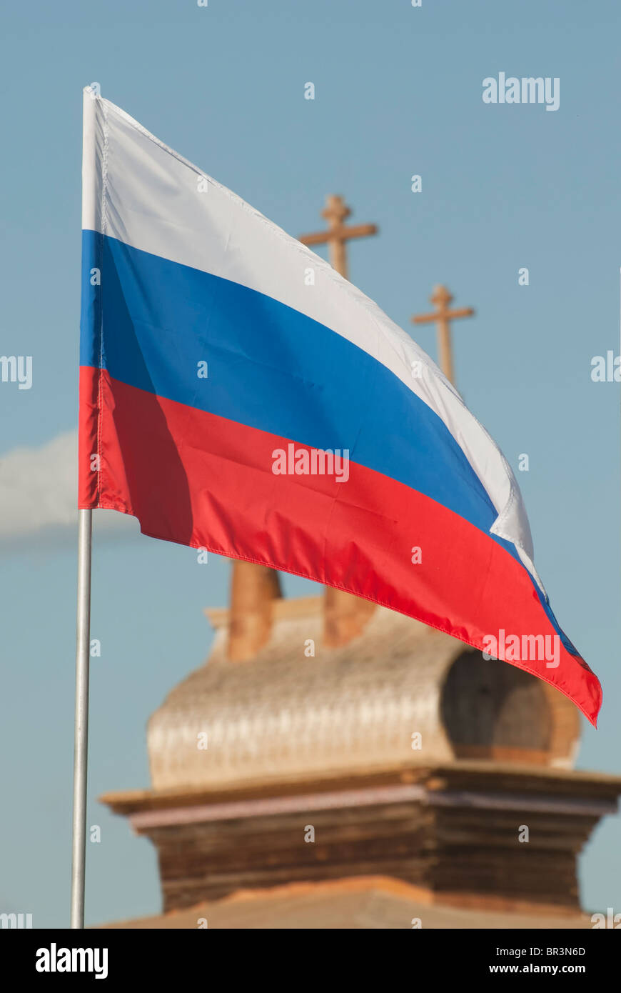 Russian flag on the Russian orthodox wooden church background Stock Photo