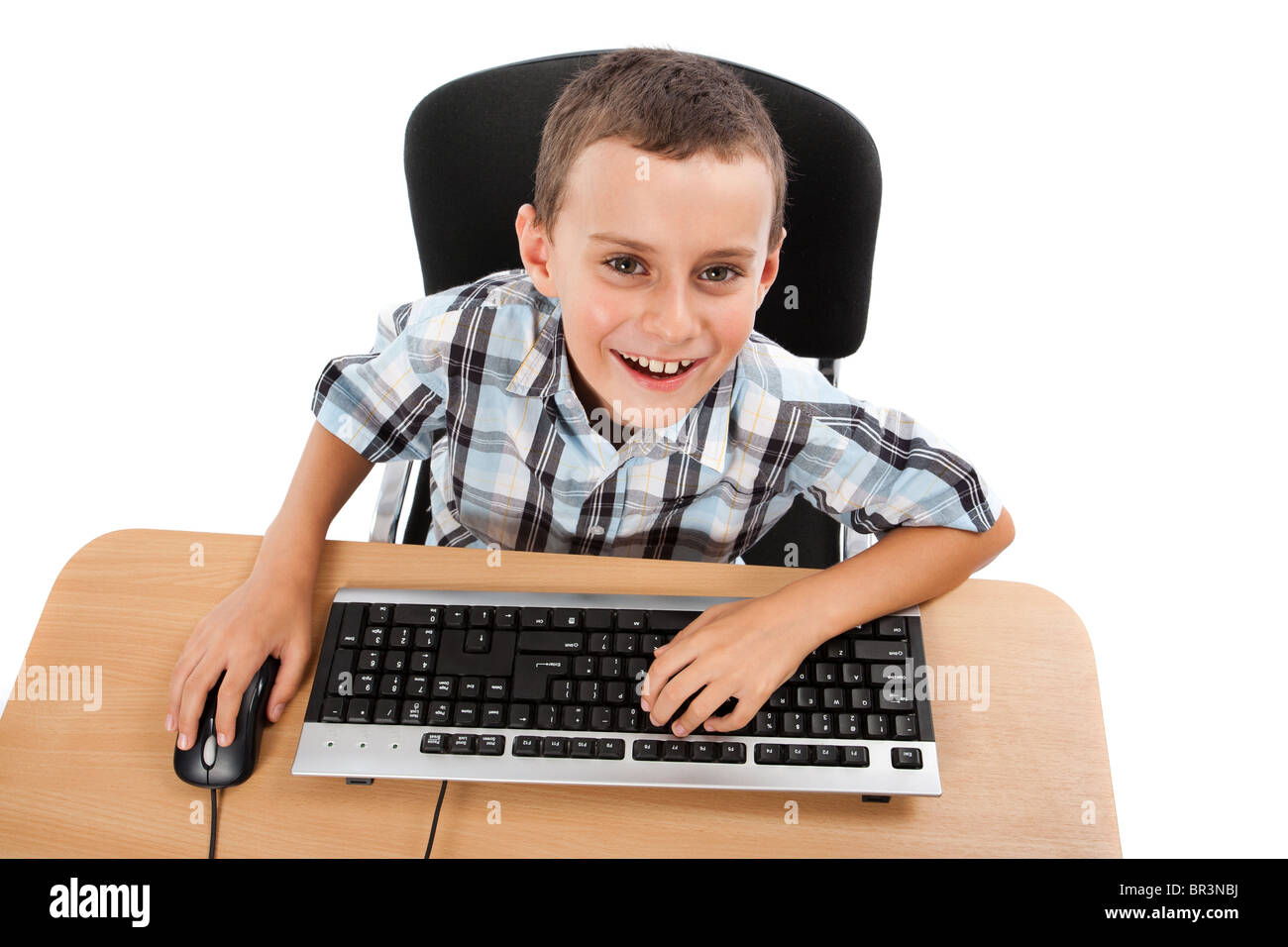 Cute schoolboy using keyboard and mouse, isolated on white background ...