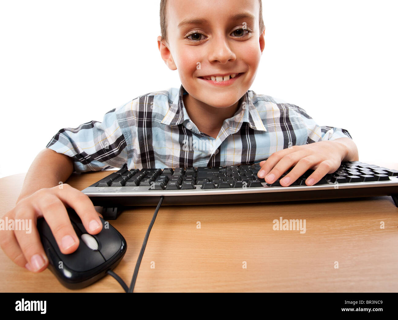 Cute schoolboy using keyboard and mouse, isolated on white background ...