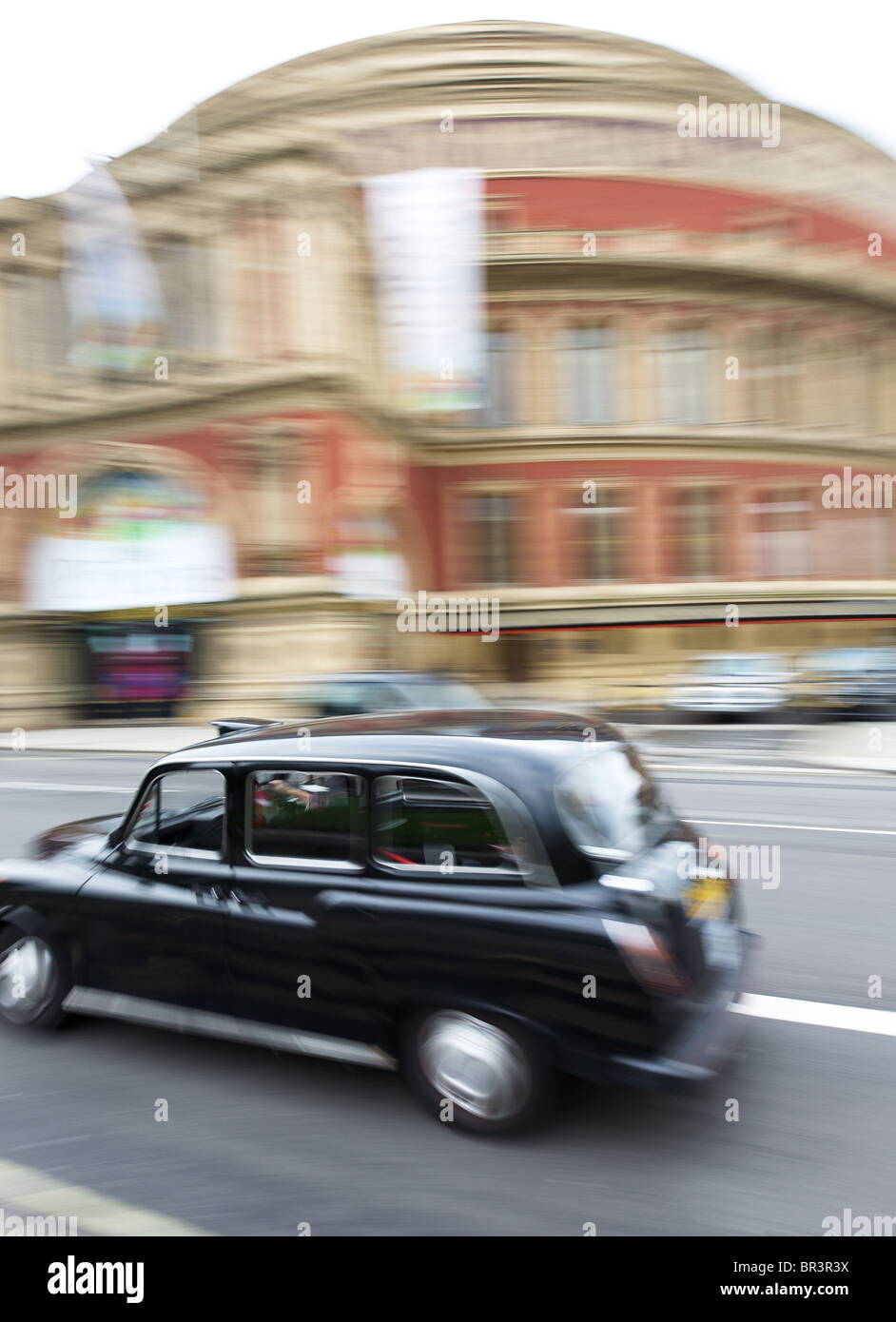 Taxi passing the Royal Albert Hall, South Kensington, London Stock Photo