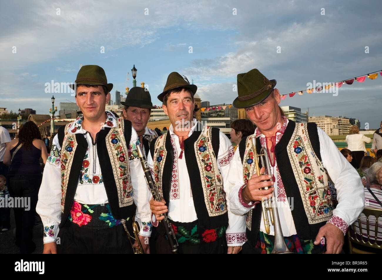 Romanian men in cultural ethnographic outfits, band players at Mayor Thames Festival, Southwark Bridge, London, England, UK Stock Photo