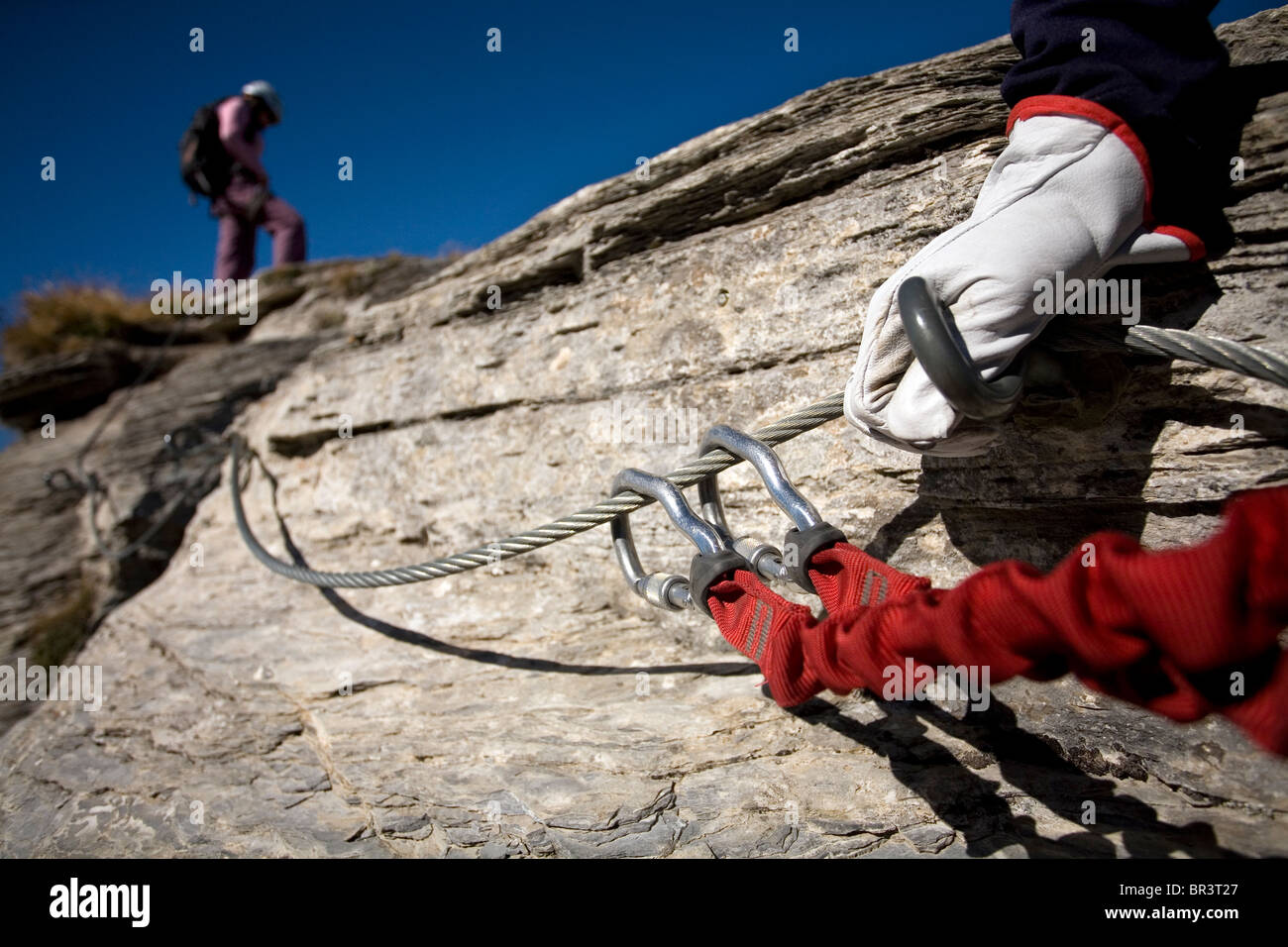 A closeup of the technical gear attached to the cable in the sport of Via Ferrata Stock Photo