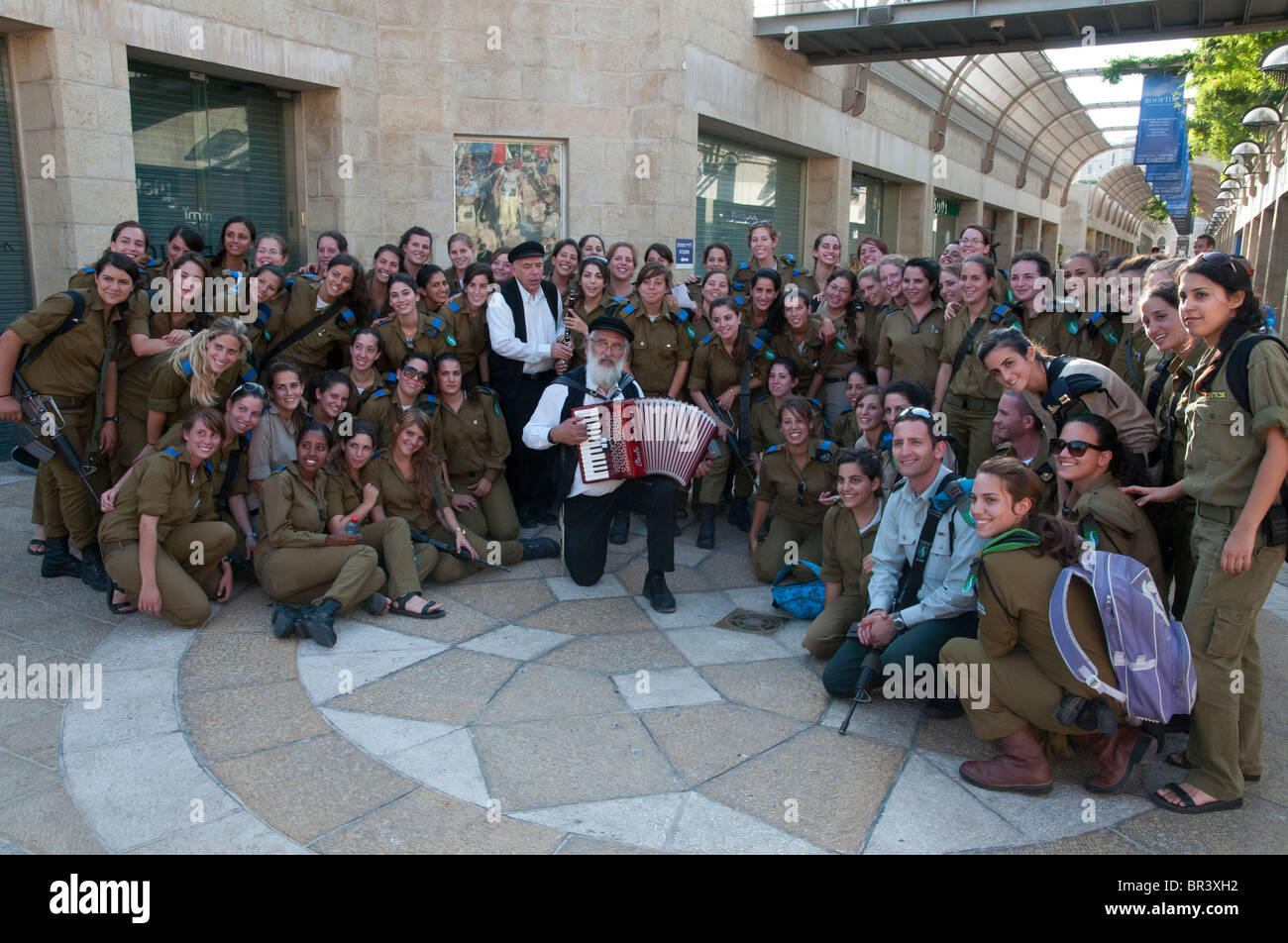 a group of female soldiers dansing to the sound of two klezmer musicians as part of their visit in Jerusalem Stock Photo