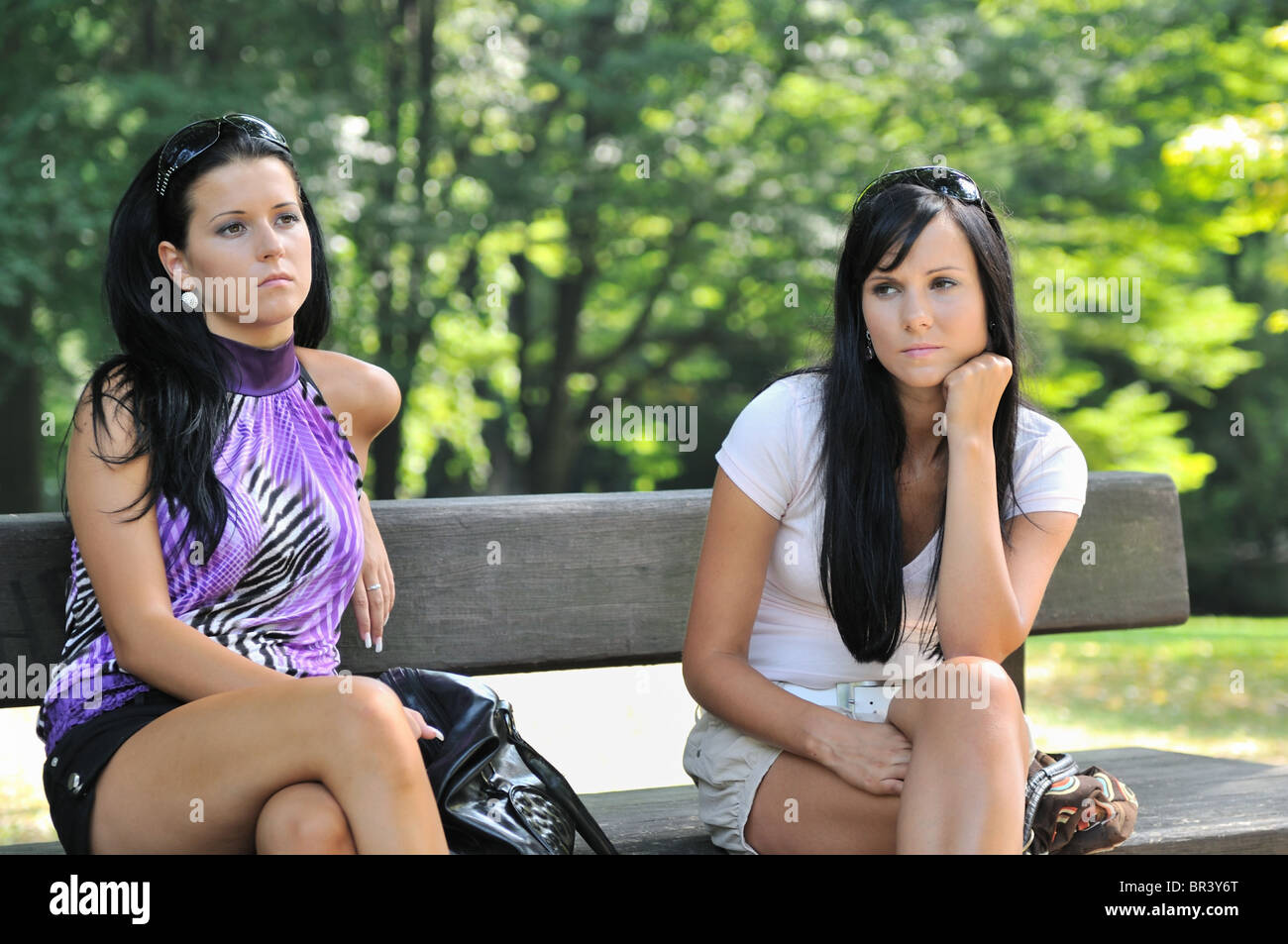 Sad Teenage Girls Siting On Bench In Park Frendship Problems