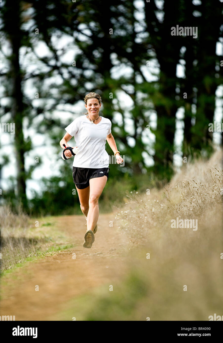 Woman trail running Stock Photo - Alamy