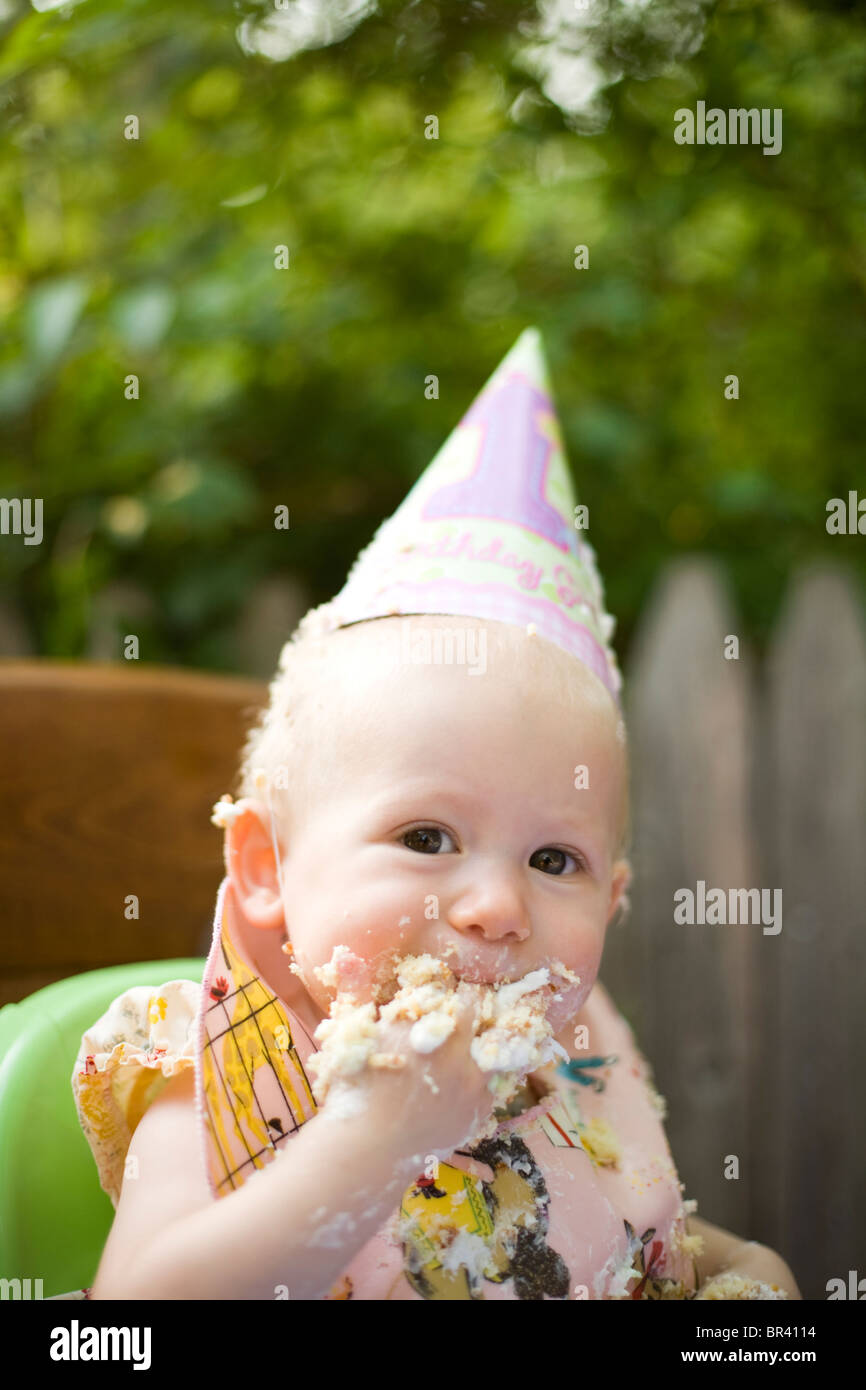 A baby girl celebrates her birthday by eating cake in Philadelphia, Pennsylvania Stock Photo