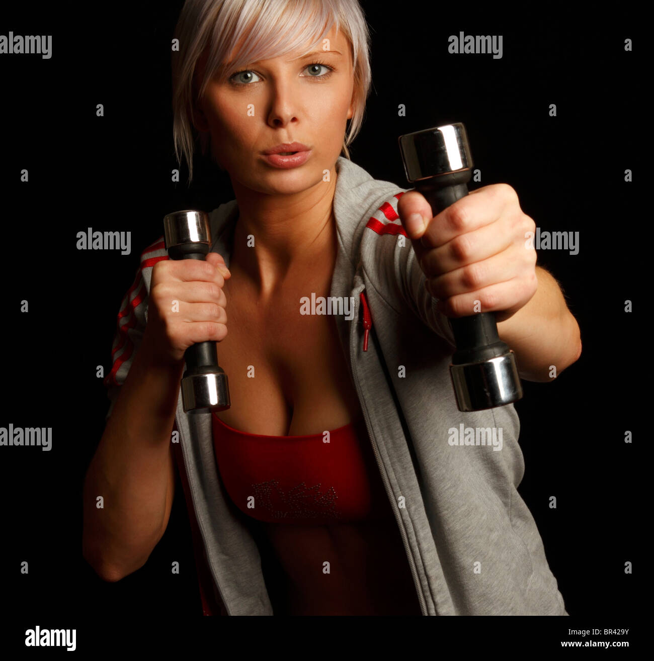 Exercising with hand weights as part of a fitness routine Stock Photo