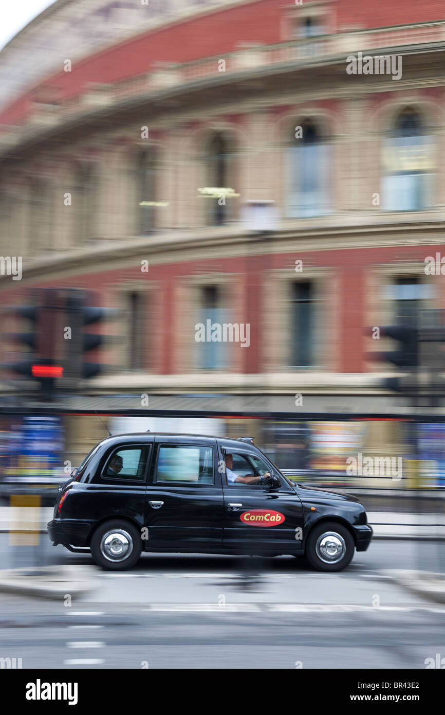 London taxi at speed passing the Royal Albert Hall Stock Photo