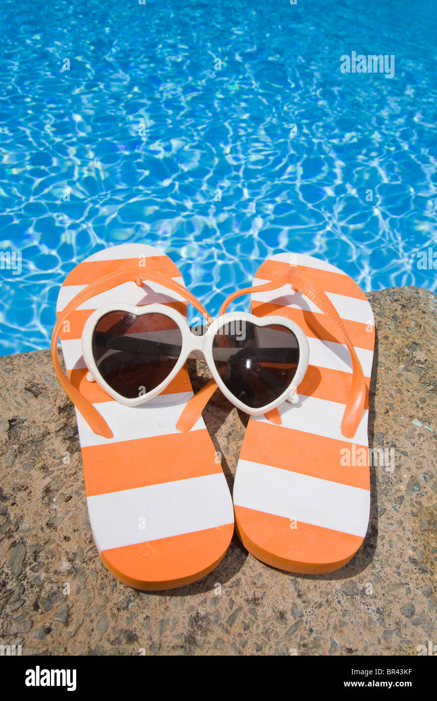 Flip flops and sunglasses by swimming pool hi-res stock photography and ...