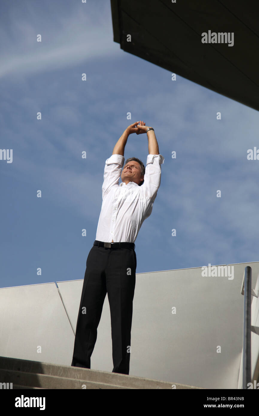 Businessman raising his arms outdoors Stock Photo - Alamy