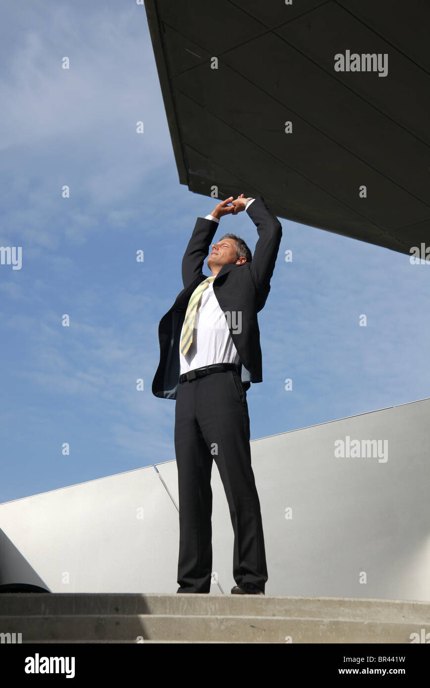 Businessman raising his arms outdoors Stock Photo - Alamy