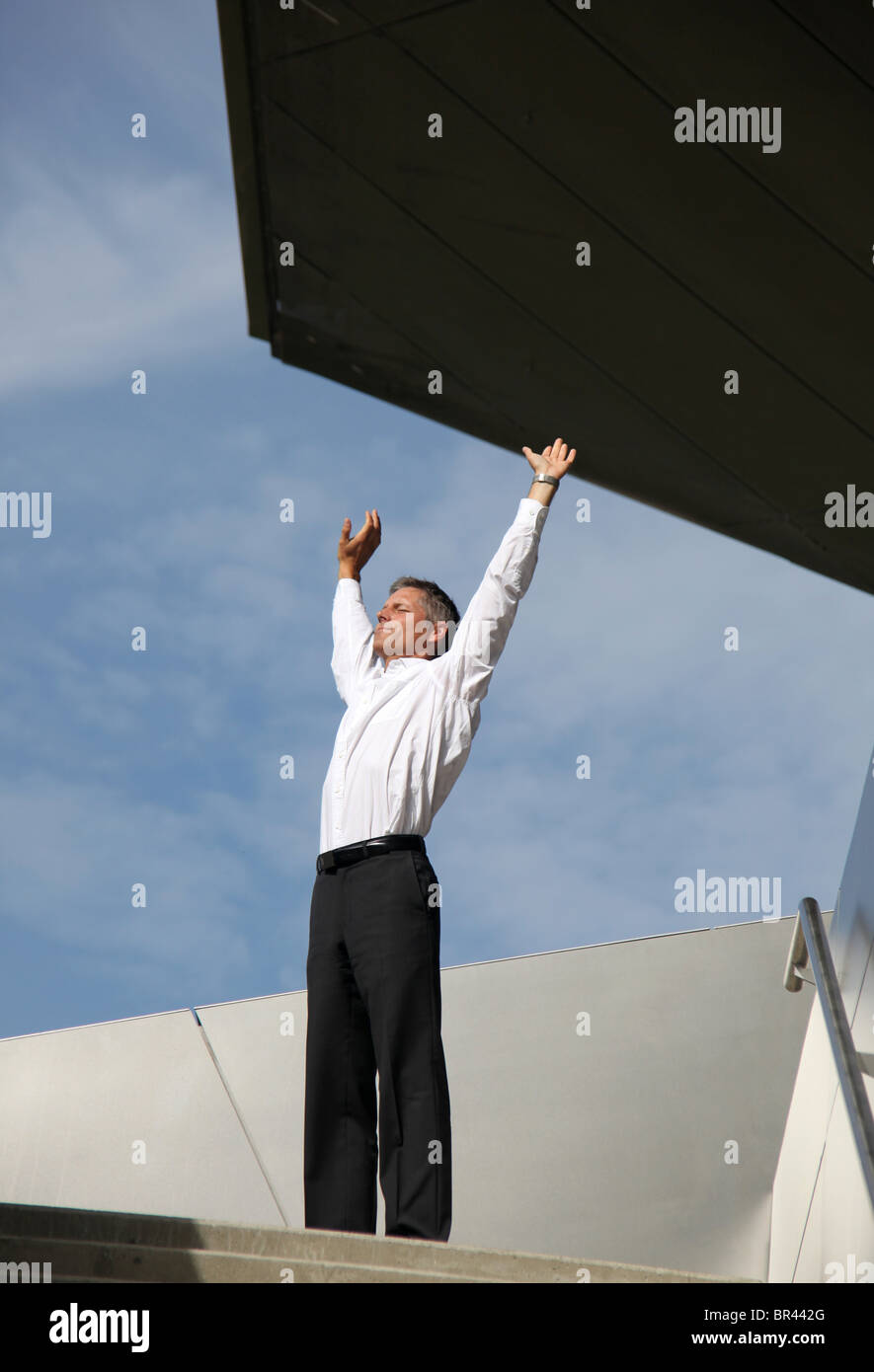 Businessman raising his arms outdoors Stock Photo - Alamy