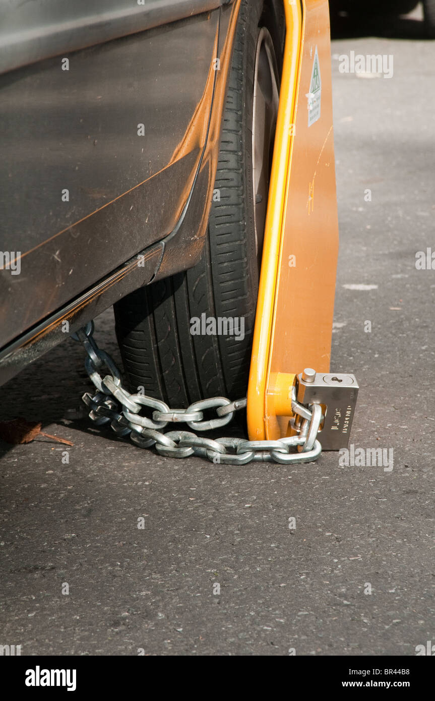 Illegal, untaxed and wheel clamped car in public street Stock Photo Alamy