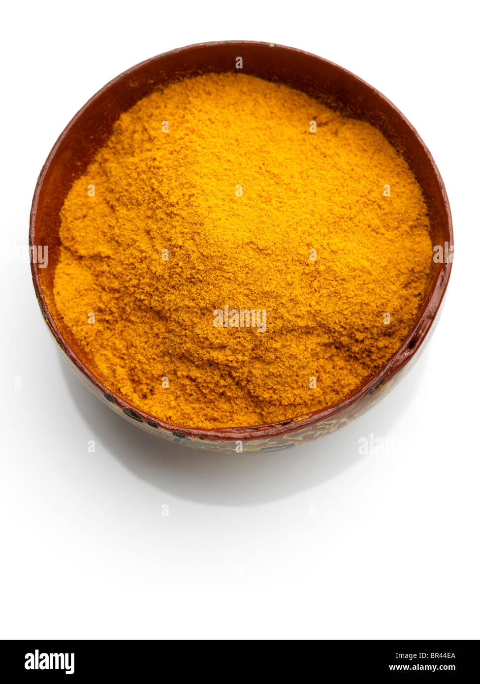 A bowl of turmeric on a white background Stock Photo