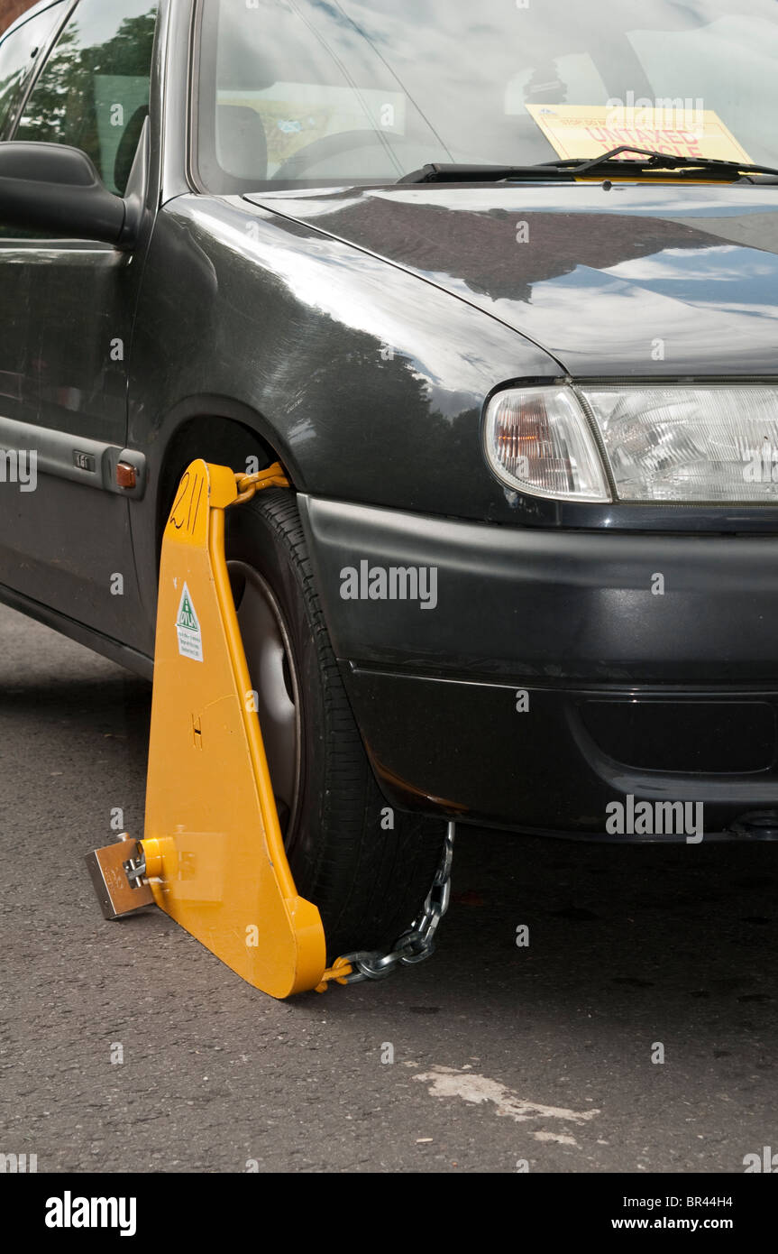 Illegal, untaxed and wheel clamped car in public street Stock Photo Alamy
