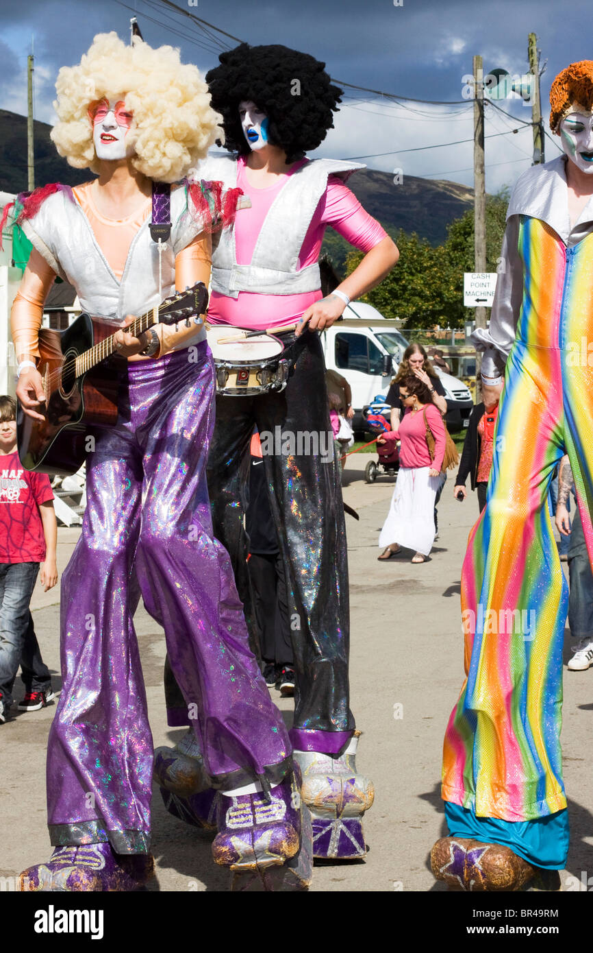 Men on stilts dressed as Rockers Stock Photo