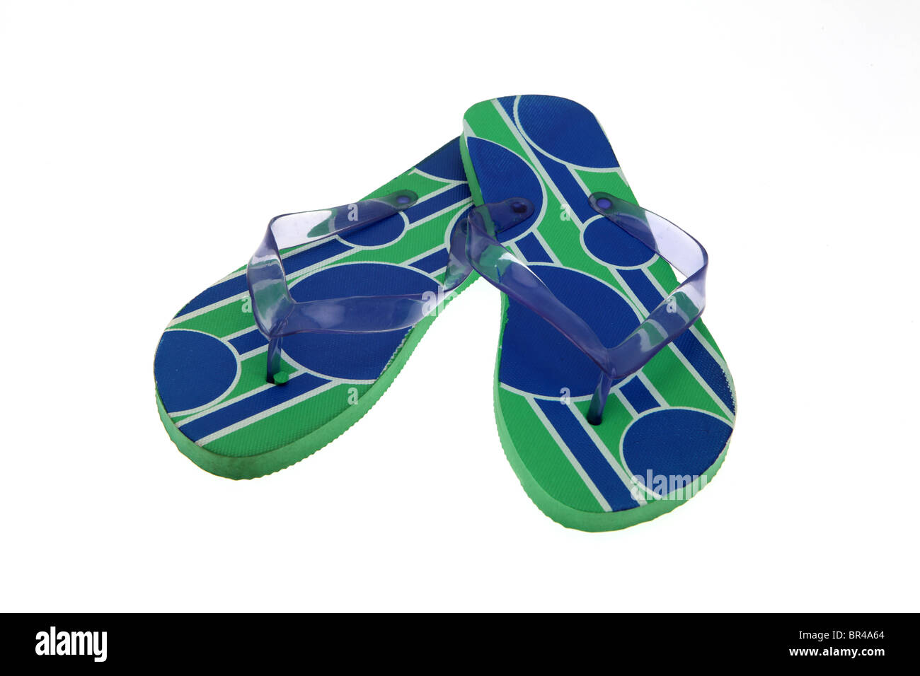Pair of green and blue pattern flip-flops - white background with a ...