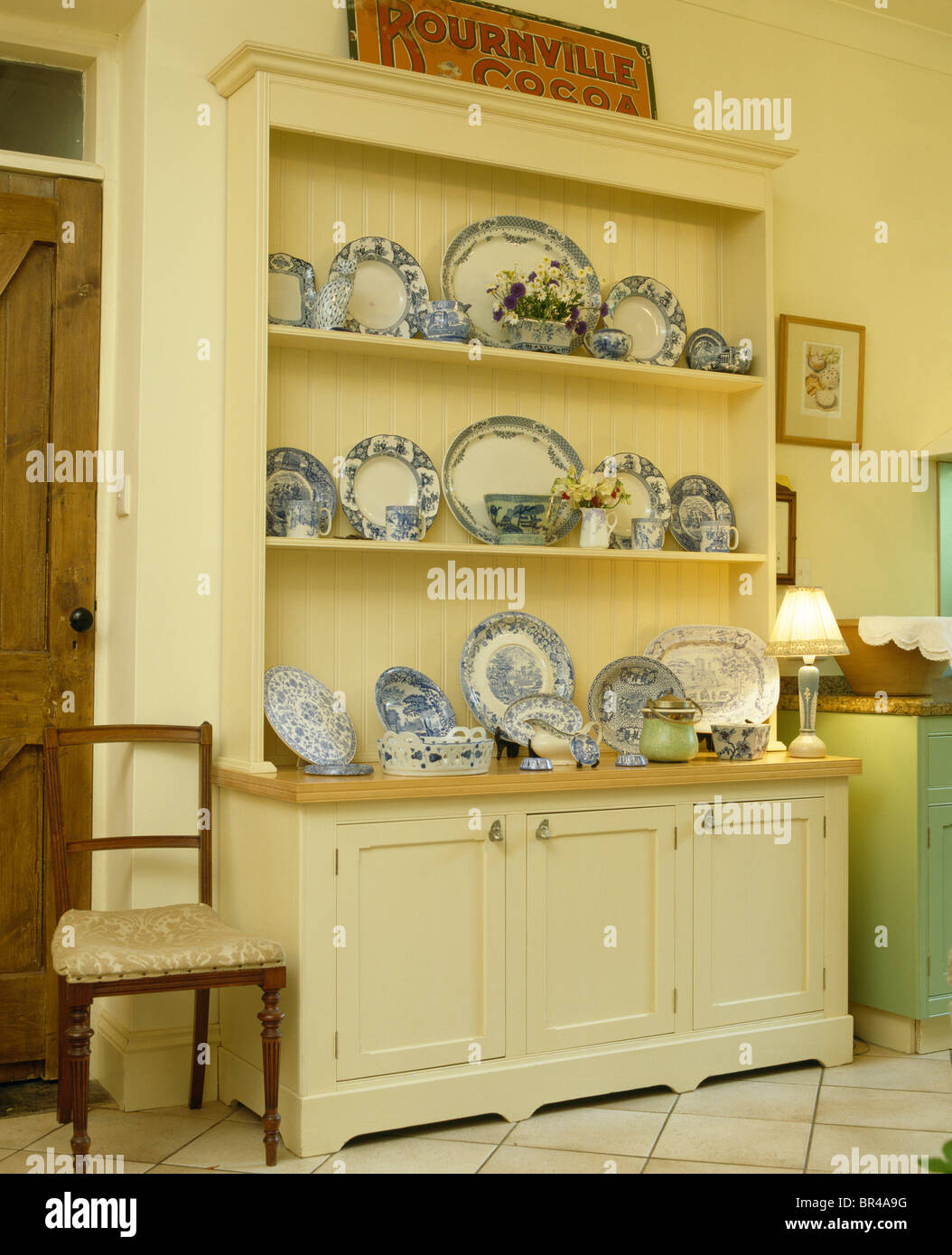 Collection Of Blue White Antique Plates On Cream Dresser In